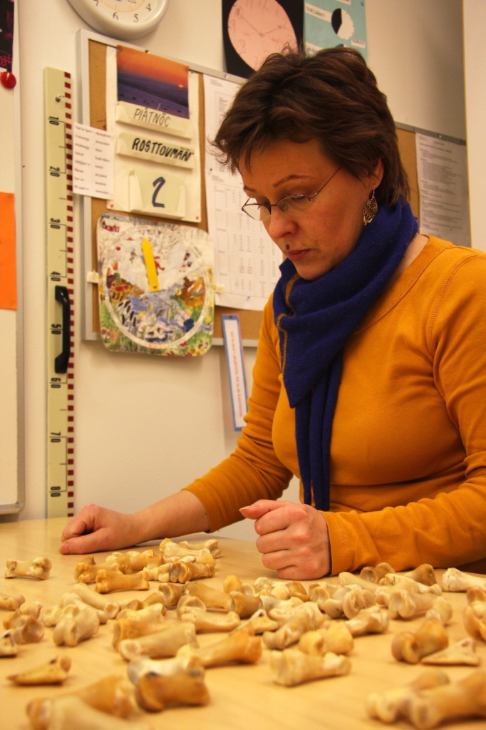 Seija playing a traditional reindeer bone game in the Sevettijärvi school.